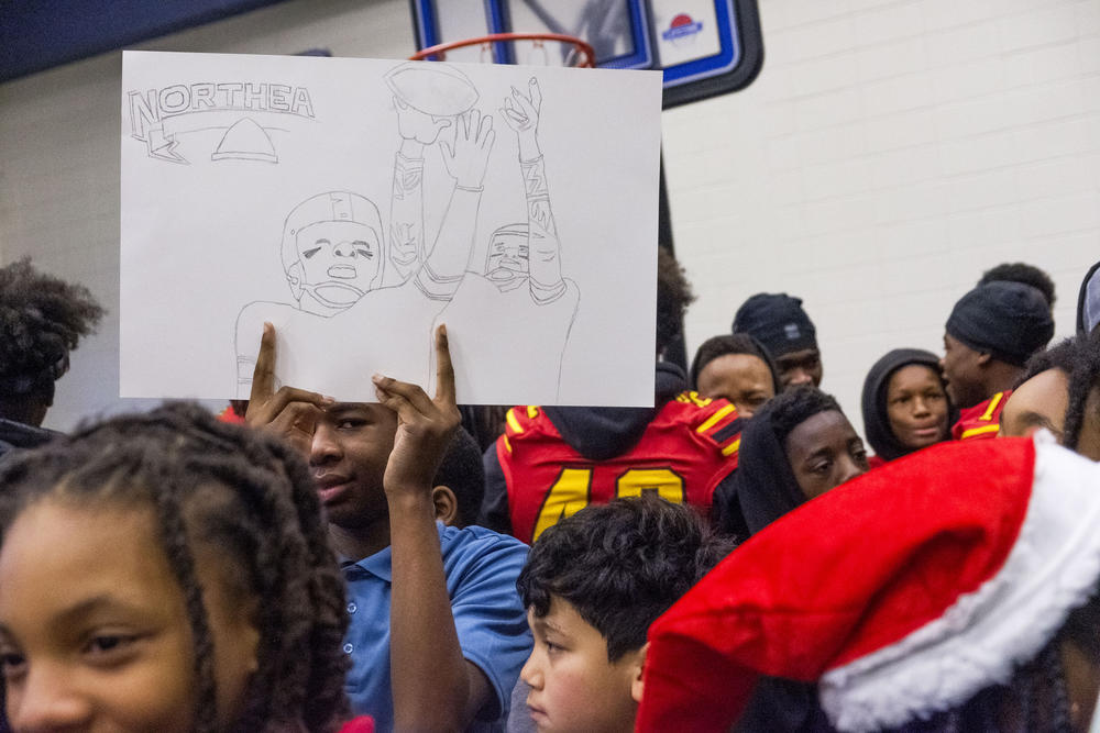 Students at Macon’s Martin Luther King Jr. Elementary School in their gymnasium, waiting on the Northeast Raiders to arrive Monday. 