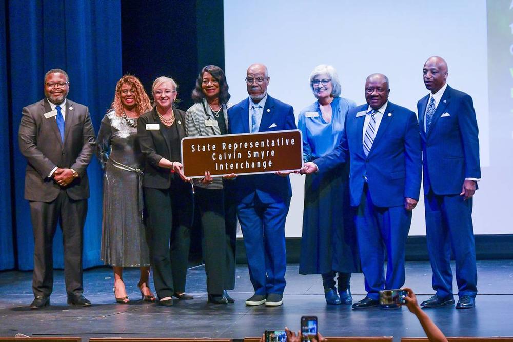 Former state Rep. Calvin Smyre of Columbus is joined on the Rainey-McCullers School of the Arts stage by members of the local legislative delegation Dec. 18, 2024, at the ceremony celebrating the naming of the intersection of I-185 and Macon Road as the Calvin Smyre Interchange. Darrell Roaden Special to the Ledger-Enquirer