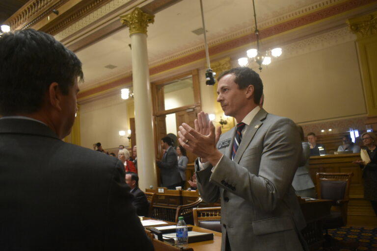 Sen. Greg Dolezal applauds the passage of his school voucher bill. Ross Williams/Georgia Recorder