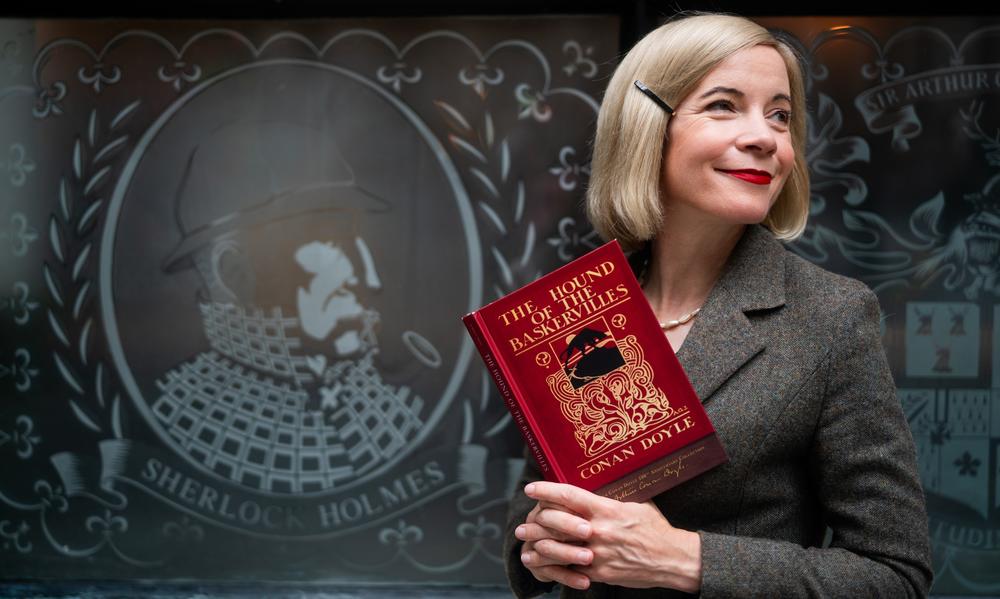 Lucy Worsley holding a book.