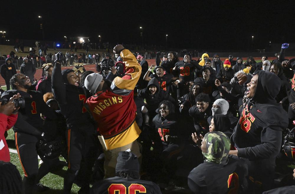 Northeast head coach Jeremy Wiggins celebrates with players after the Raiders’ 46-14 win over Fitzgerald in Friday night’s GHSA state semifinal game. Jason Vorhees / The Melody