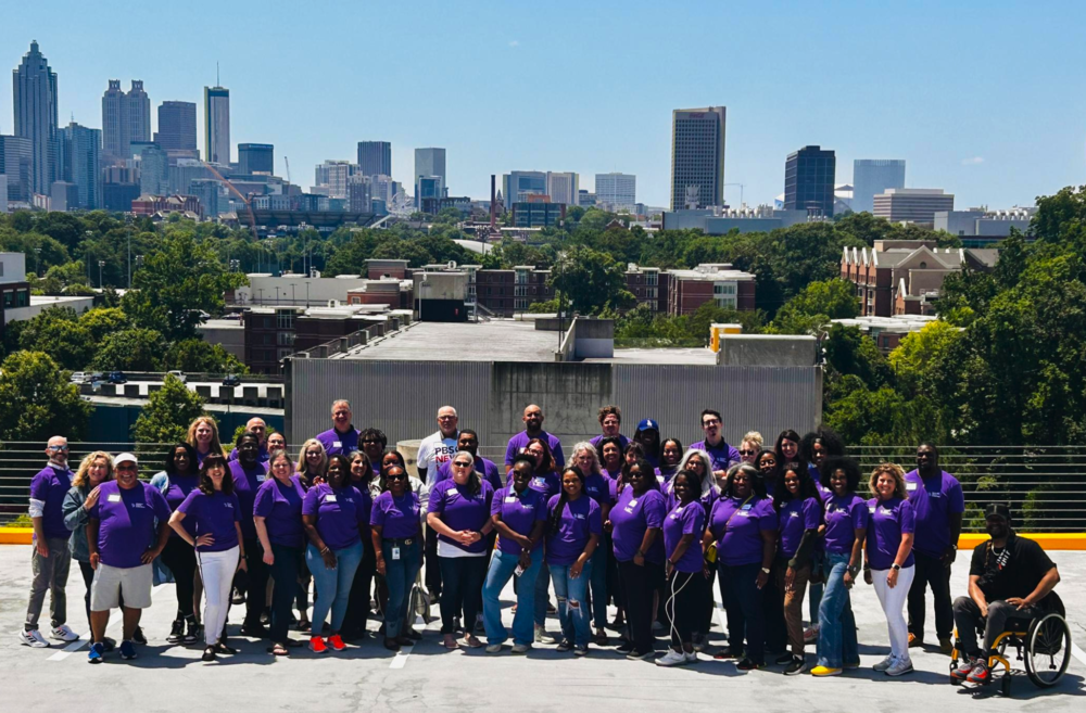 Teachers from around the state pose in front of Atlanta skyline. 