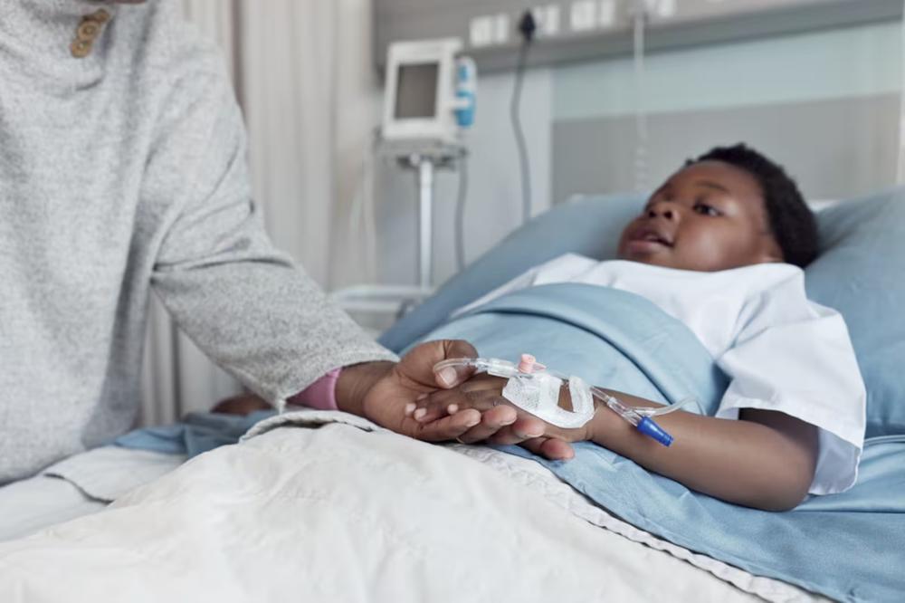 A young patient with sickle cell anemia in a hospital bed