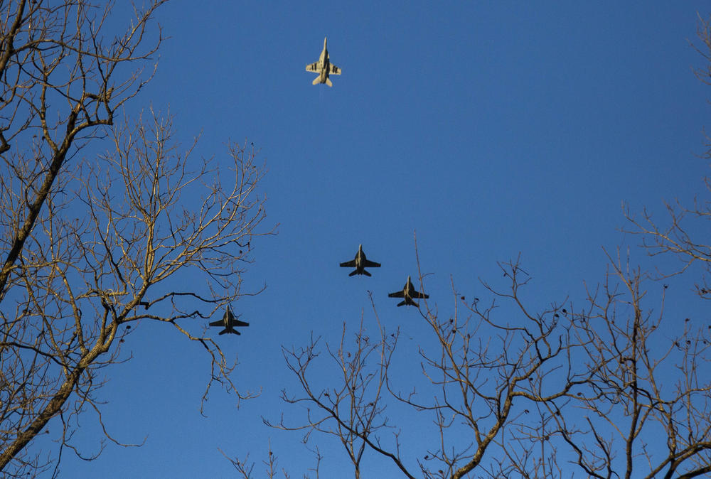 A Navy F-18 fighter jet breaks away in the "missing man" formation in honor of Jimmy Carter over Carter's home church before his funeral in Plains, Ga. Thursday. 