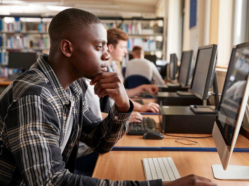 Students look at computer screens.