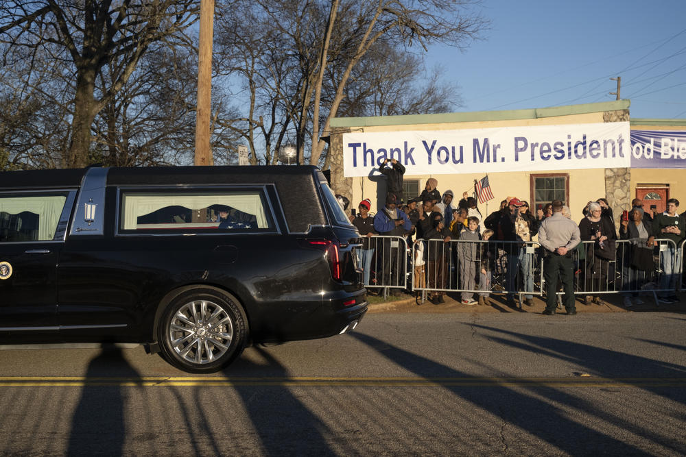 For the last time, onlookers welcome back former President Jimmy Carter from Washington D.C., and watch as the hearse carrying Carter’s casket travels to Maranatha Baptist Church in Plains, G.a. on Thursday. 