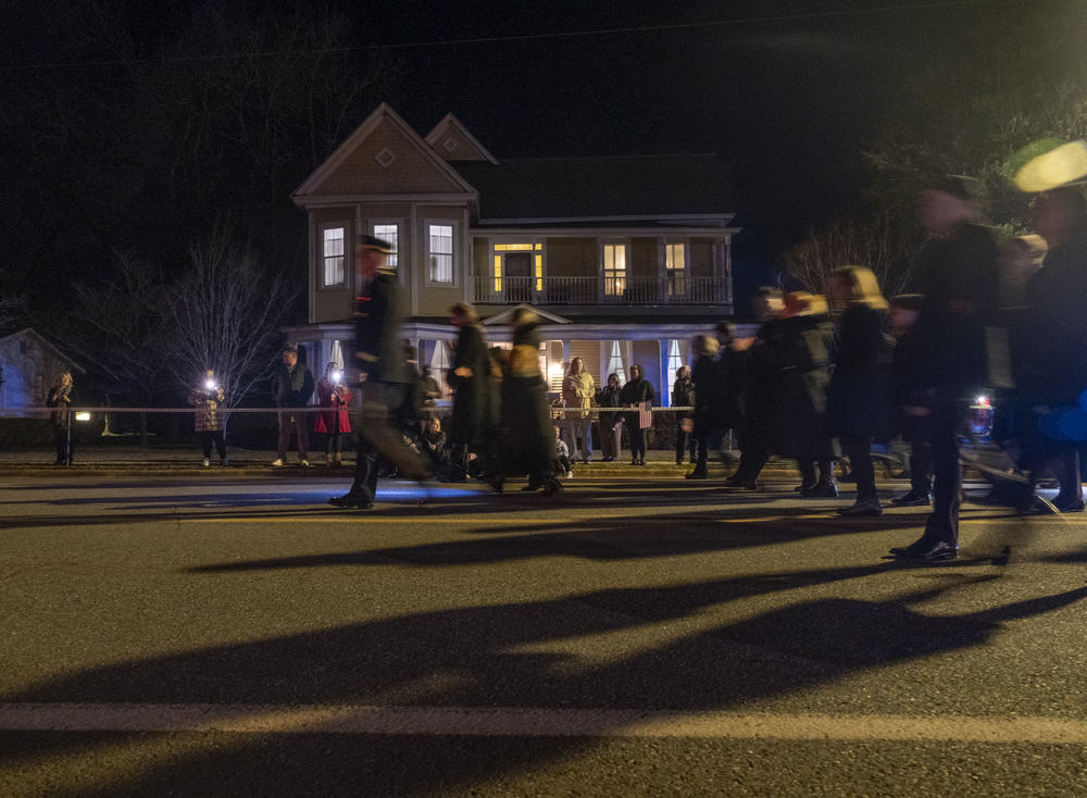 At nightfall on Thursday, the Carter family walk behind the hearse carrying Jimmy Carter’s casket, through downtown Plains and toward Jimmy and Rosalynn’ home for a private ceremony. 