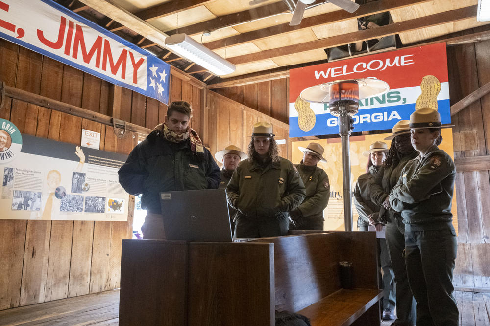 National Park Service rangers stream former president Carter’s funeral live from the Washington National Memorial, huddled against the cold inside the old Plains train depot, now a museum. 