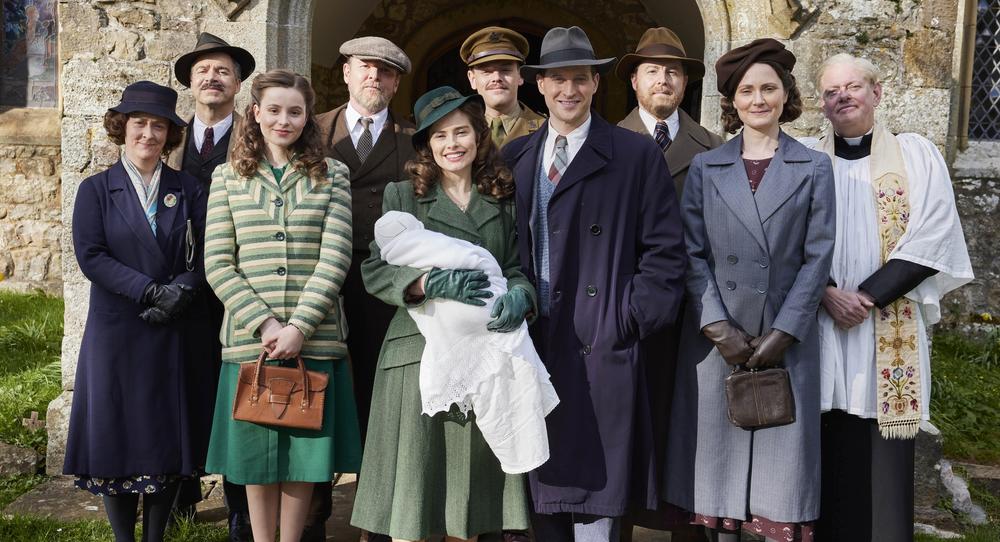 Shown L-R: Hannah Herriot (Gabriel Quigley), James Herriot Sr (Drew Cain), Jenny Alderson (Imogen Clawson), Richard Alderson (Tony Pitts), Helen Herriot (Rachel Shenton), Tristan Farnon (Callum Woodhouse), James Herriot (Nicholas Ralph), Siegfried Farnon (Samuel West), Mrs. Hall (Anna Madeley), Vicar (Mark Chatterton) 