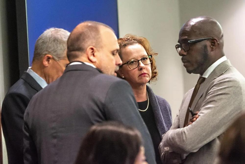 Former Brunswick Judicial Circuit District Attorney Jackie Johnson, second from right, speaks to her legal team Tuesday at the Glynn County Courthouse in Brunswick that includes Brian Steel, left, Jason Clark, second from left, and Keith Adams, right. Tuesday was the first day of jury selection in Johnson’s trial on charges of obstruction and violation of oath of office. (Michael Hall/Brunswick News)