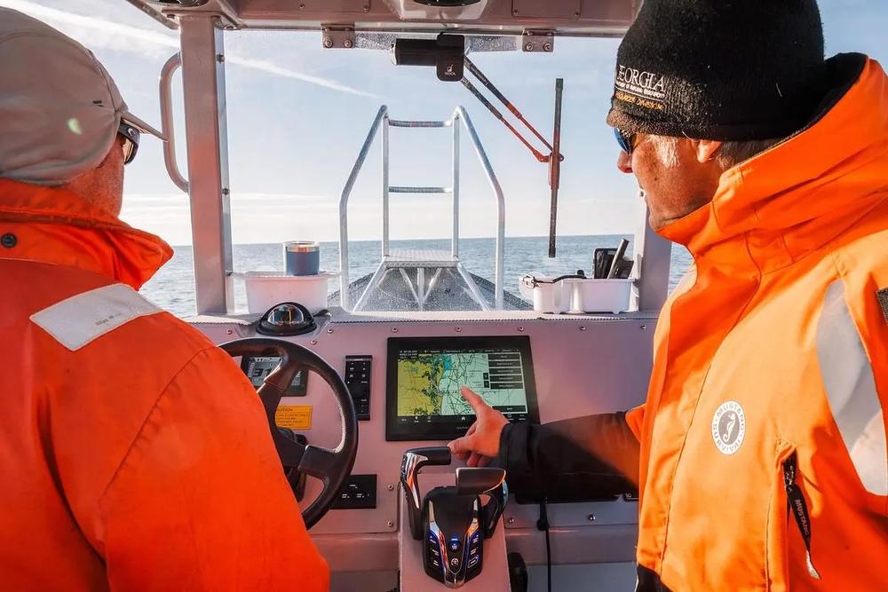 Senior Wildlife Biologist Mark Dodd uses GPS data relayed from the aerial survey team to locate an endangered North Atlantic right whale near St. Marys, Jan. 26, 2025.  Credit: Justin Taylor/The Current GA