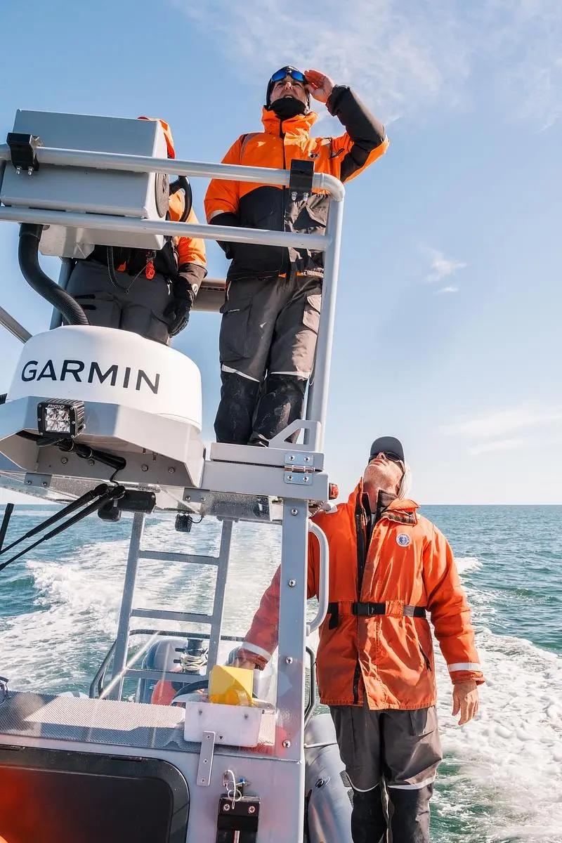 Senior Wildlife Biologist Mark Dodd and Wildlife Technician Trip Kolkmeyer search for an endangered North Atlantic right whale near St. Marys on Jan. 26, 2025.  Credit: Justin Taylor/The Current GA