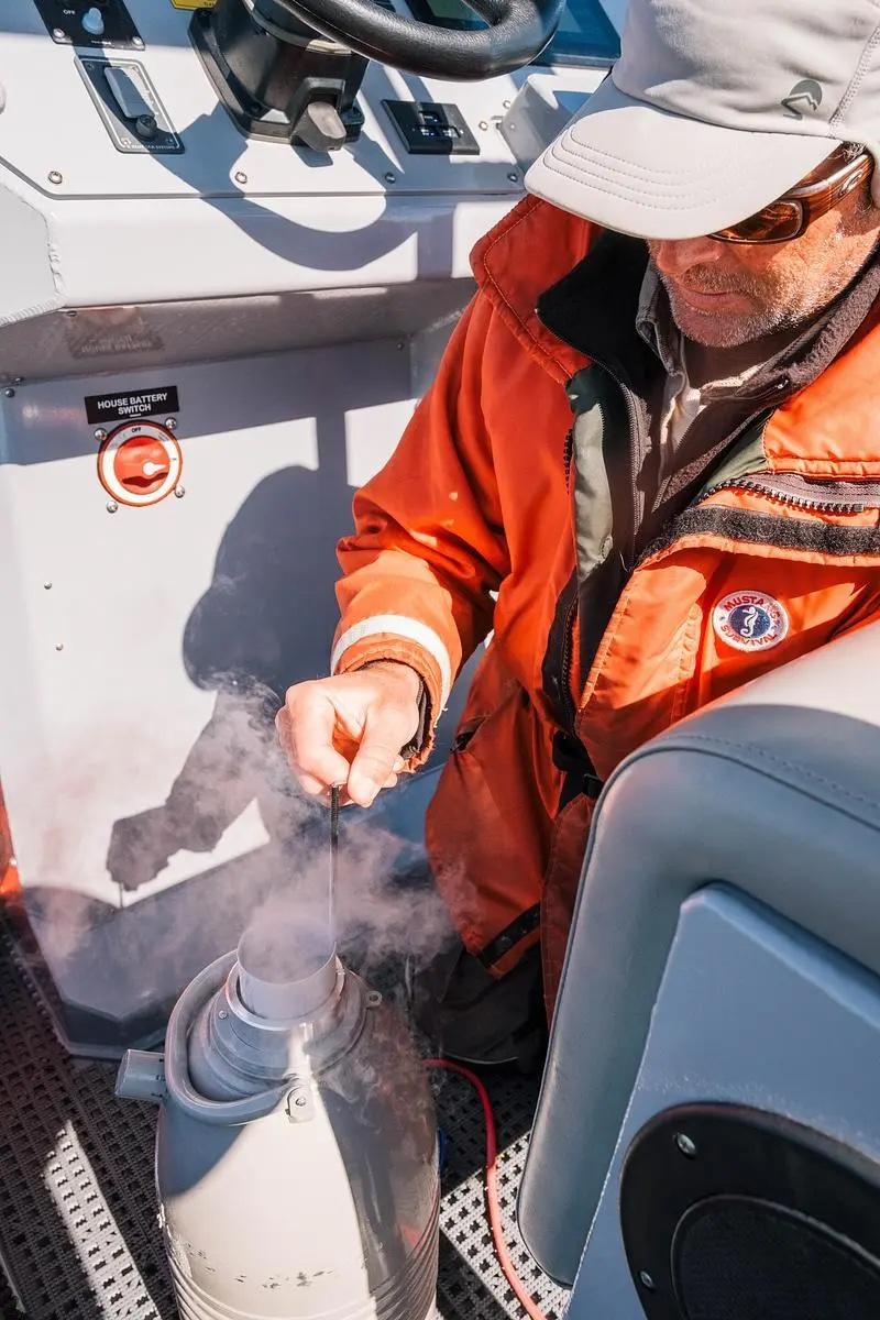 A skin and blubber sample taken from a juvenile endangered North Atlantic right whale is frozen in liquid nitrogen near St. Marys, Jan. 26, 2025. The collected samples are sent to a lab for DNA testing to determine the whale’s identity.