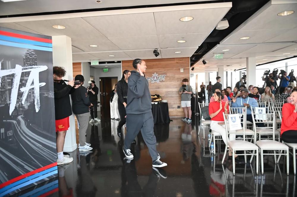 Brittney Griner (in grey sweatsuits) waves to the crowd on hand for the introductory press conference at Ventanas on Tuesday, Feb. 4, 2025. Photo by Kerri Phox/The Atlanta Voice