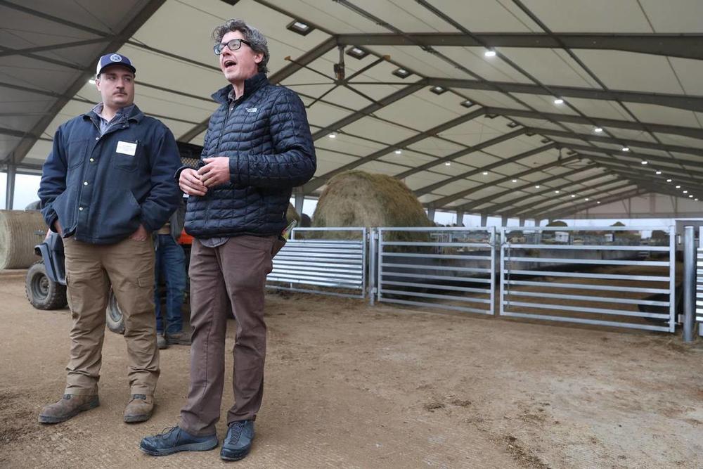 Houston Solar ranch manager Jack Mason (left) stands with Silicon Ranch agrivoltaics operations director Jim Malooley outside of the lambing barn at Houston Solar Project on Wednesday, Feb. 12, 2025, in Elko, Georgia. The lambing barn, which finished in late 2023, currently holds hundreds of sheep and lambs, which are monitored, recorded and then released out to the pasture. Silicon Ranch breeds its own sheep to enhance parasite resistance and to adapt to the climate in the southeast. Katie Tucker/The Teleg