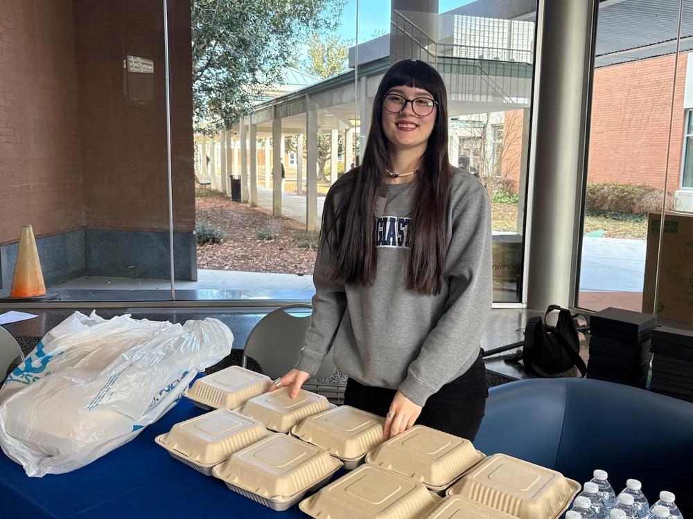 Kayla Osmon, a master of public health student at Georgia State University, helps out at the college’s Health and Wellness Expo at its Clarkston Campus on Wednesday. (Allen Siegler / Healthbeat) 