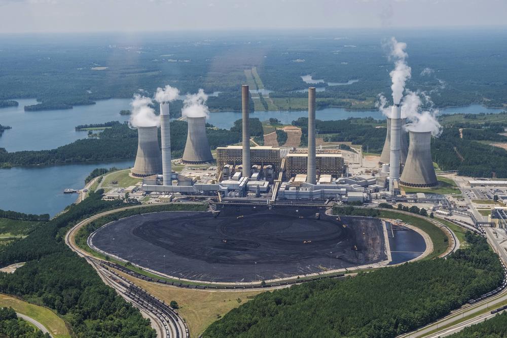 Freight trains encircle, and earth moving equipment dots, the massive coal yard in front of Georgia Power's Plant Scherer in 2019. 