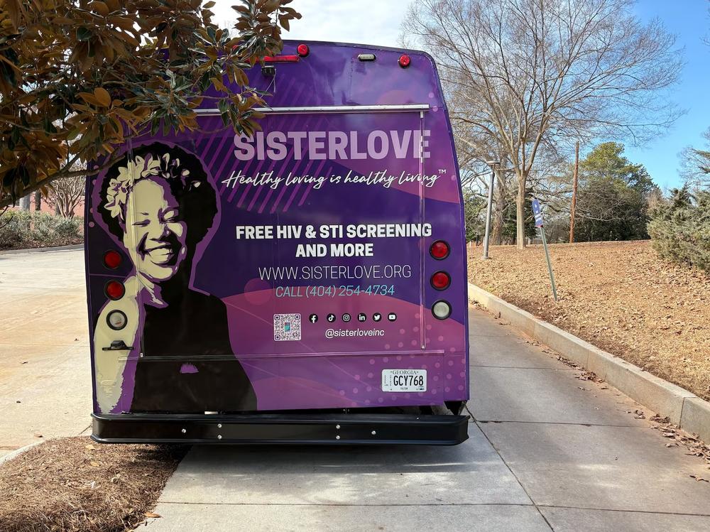 A bus for SisterLove, an Atlanta reproductive health nonprofit, is parked at the Georgia State University Clarkston Campus on Wednesday for a health expo. (Allen Siegler / Healthbeat) 