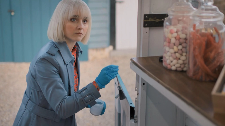 A blonde woman in a candy shop.