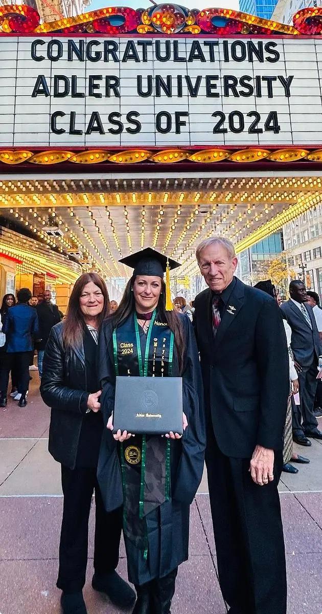 Kristen Clark-Hassell, of St. Marys, Ga., graduated with honors from an online master’s program from Adler University in Chicago in October 2024. She is seen here with her parents. (Photo courtesy of Kristen Clark-Hassell)