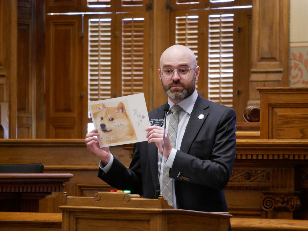  Sen. Josh McLaurin, a Sandy Springs Democrat, held up a photo of the Doge meme that became popular in 2013 and is the namesake of Elon Musk’s Department of Government Efficiency. Jill Nolin/Georgia Recorder