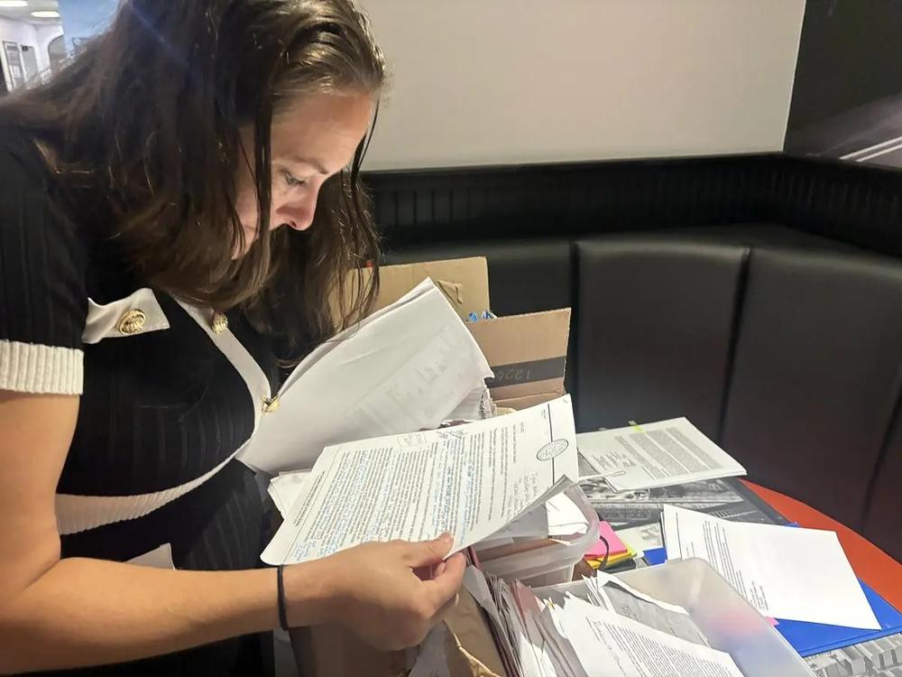 Kristen Clark-Hassell, of St. Marys, shows her voluminous files resulting from years of DFCS involvement in her children’s lives. (Jake Shore/The Current)