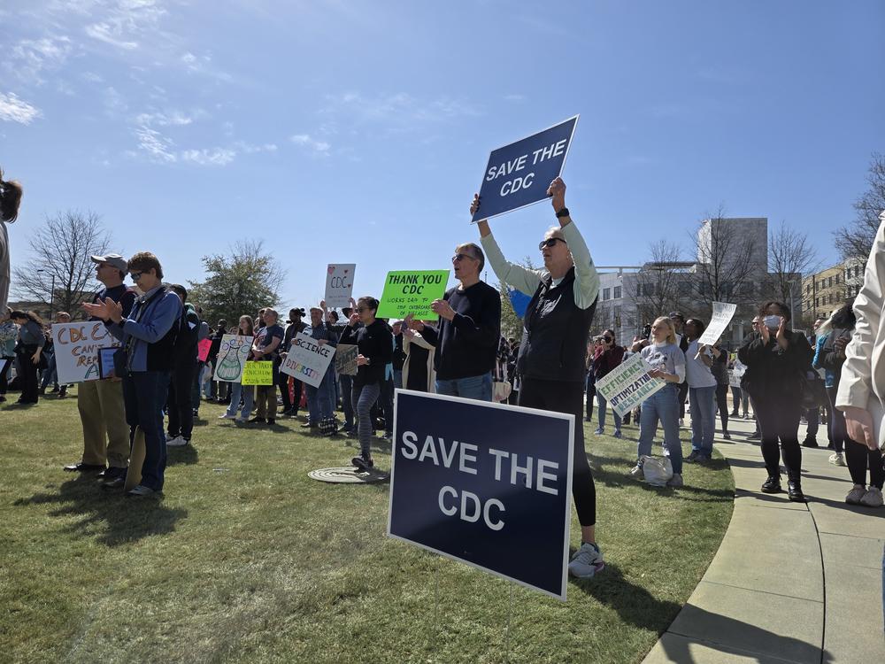 Protesters speak out against federal funding cuts affecting workers as part of a national day of action.