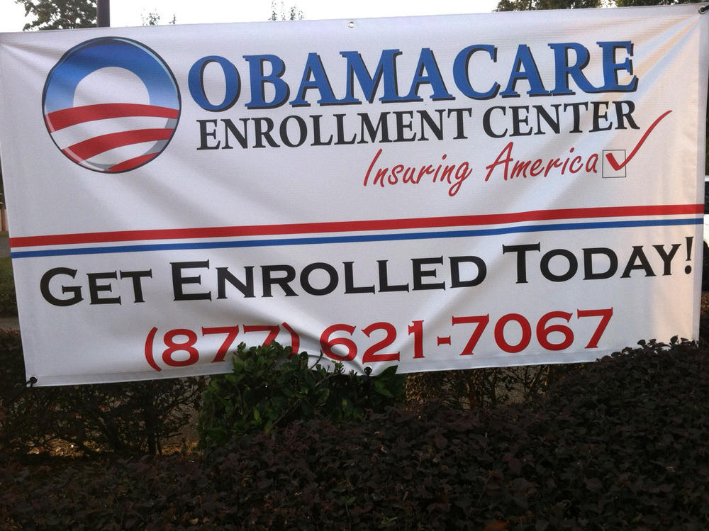 A sign encourages people to enroll in Obamacare.