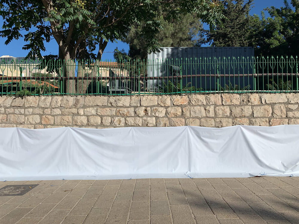 A pro-LGBTQ banner is flipped over on a wall outside the U.S. Embassy in downtown Jerusalem.