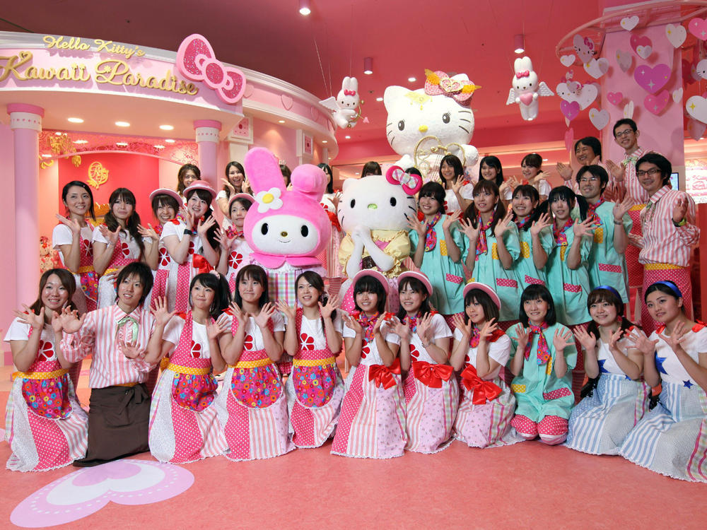 Staff at Tokyo's Hello Kitty Kawaii Paradise theme park pose for photos at a preview in a shopping mall in 2010.