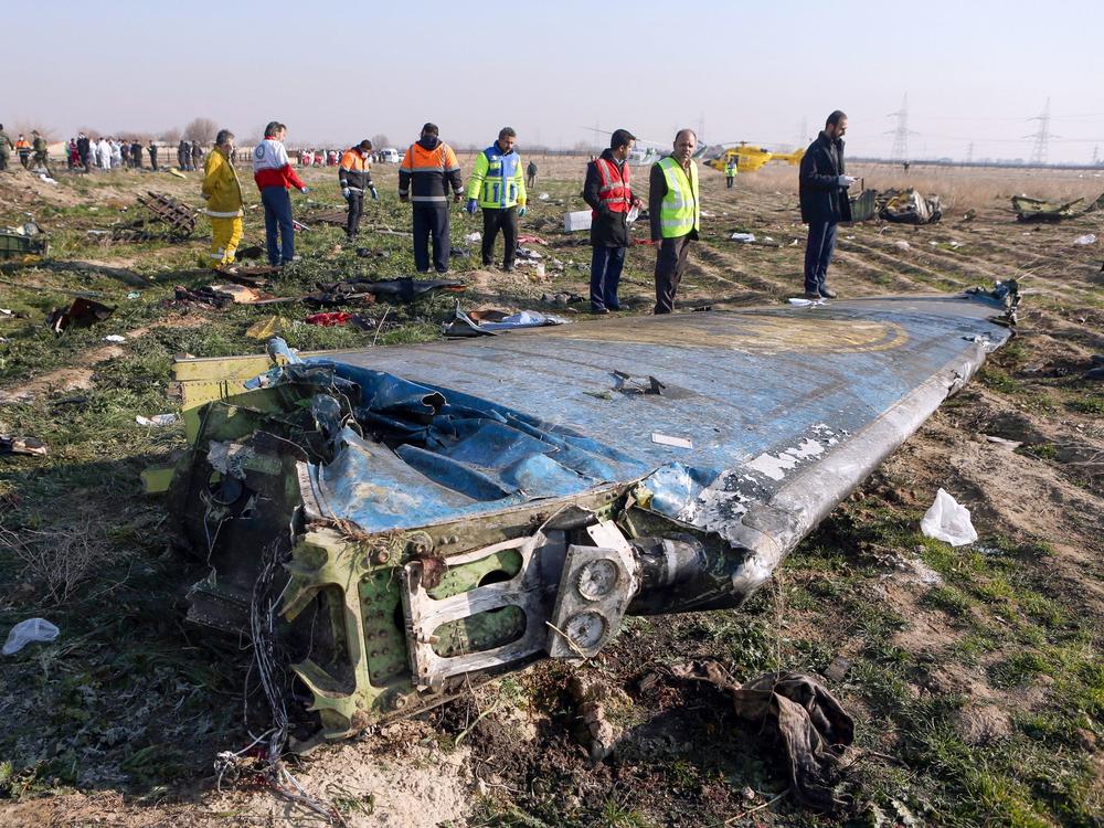 Rescue teams examine the wreckage of the Ukrainian airliner that was shot down shortly after takeoff in the Iranian capital, Tehran, on Jan. 8. Iran says a tragic series of mistakes led to the missile strike.