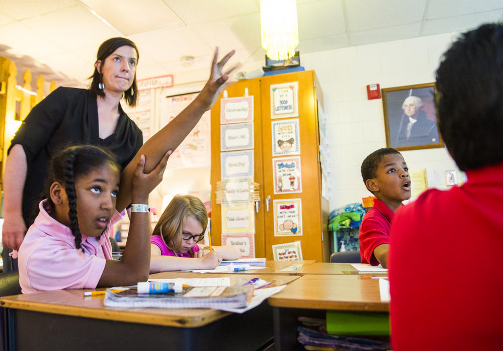 Third grade teacher Megan Causey, left, has doubts about the Georgia Milestones pass/fail policy.  