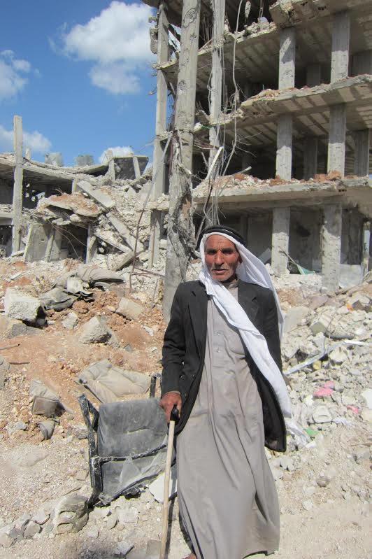 A man stands in the destroyed Syrian town of Kobani.