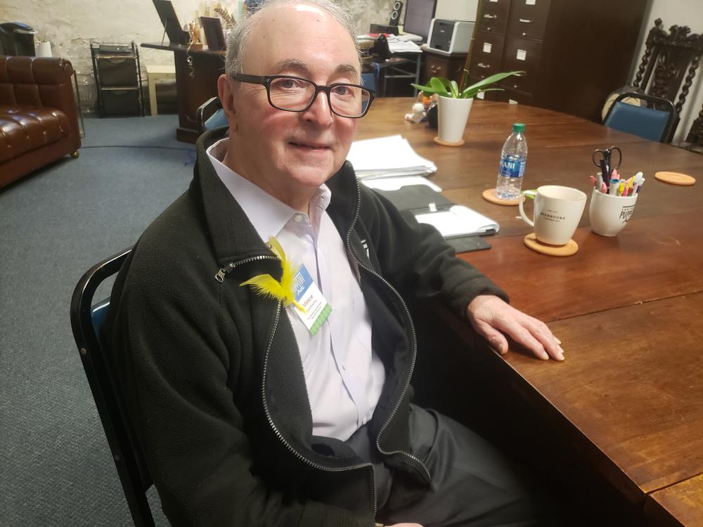Center for Puppetry Arts executive director Vince Anthony joined other staff in wearing a yellow feather lapel in tribute to Spinney.