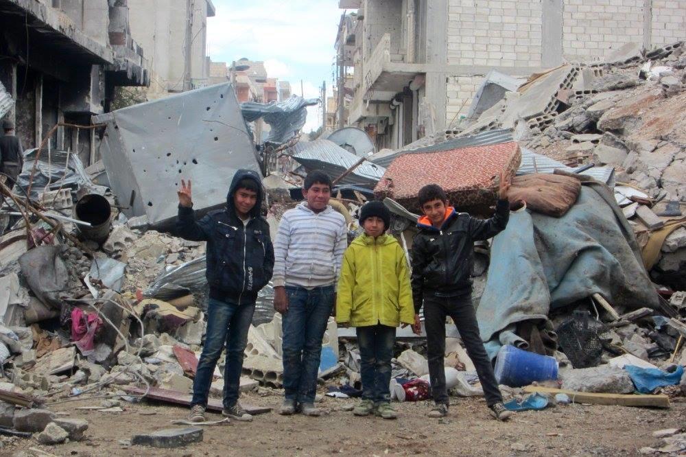 Young children in the destroyed Syrian town of Kobani.