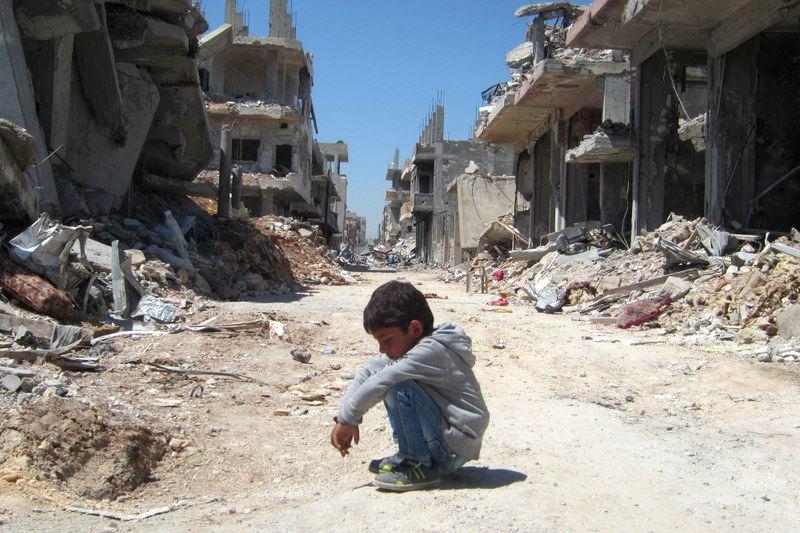 A young child in the destroyed Syrian town of Kobani.