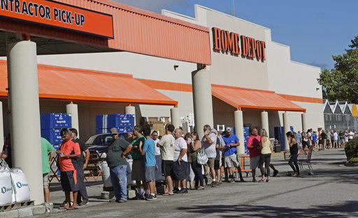 People line up outside a Home Depot for a new supply of generators and plywood in advance of Hurricane Florence in Wilmington, N.C., on Sept. 12, 2018.