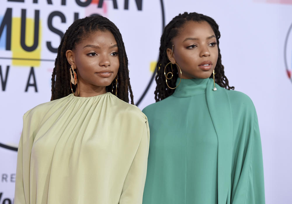 Halle Bailey, left, and Chloe Bailey, of Chloe x Halle, arrive at the American Music Awards on Tuesday, Oct. 9, 2018, at the Microsoft Theater in Los Angeles. 