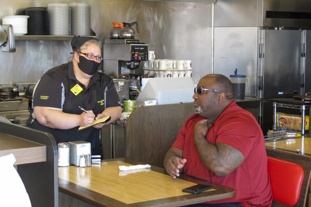 Corey Brooks, right, orders food at a Waffle House restaurant in Savannah, Georgia, on Monday, April 27, 2020. 