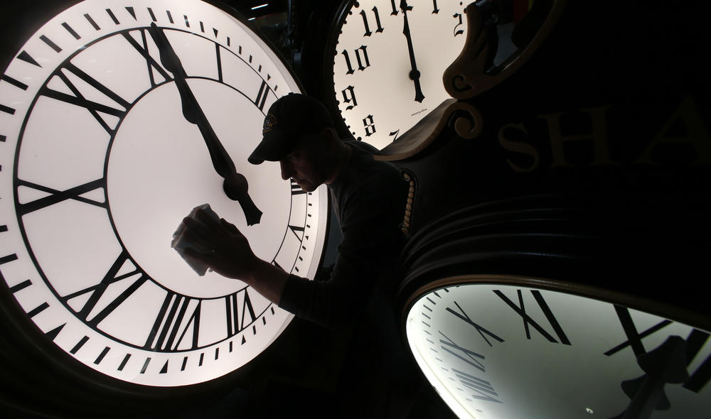 Dave LeMote wipes down a post clock at Electric Time Company, Inc. in Medfield, Mass., Friday, March 7, 2014.