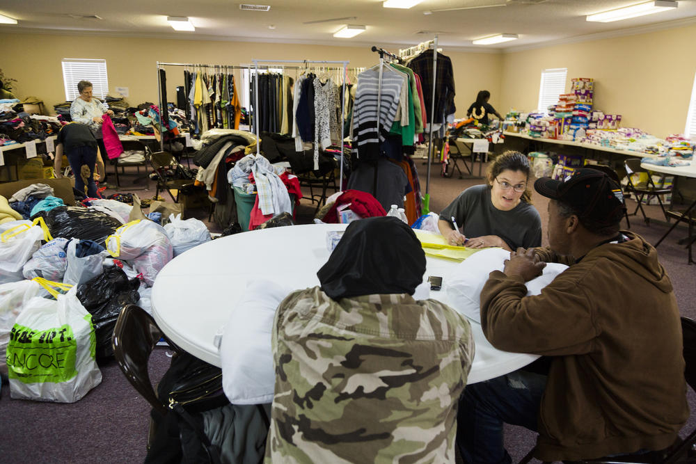 Caption/Description: First Assembly Church of God in Adel was the hub for storm relief activity as people made homeless by the weekend's storm looked for clothes, food and shelter.