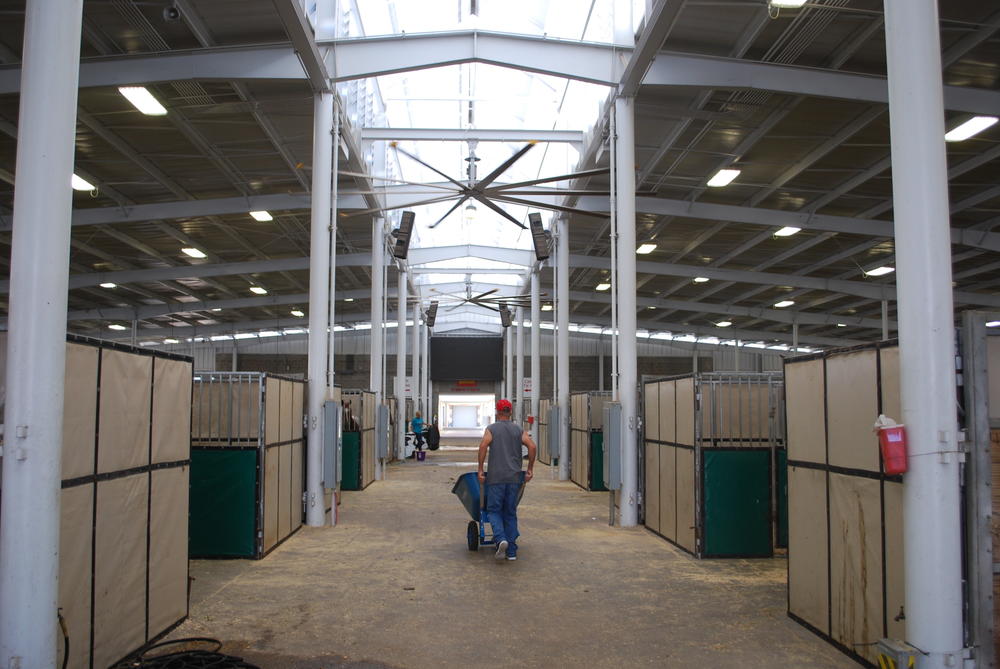 A horse owner hauls shavings at the Georgia National Fairgrounds. 