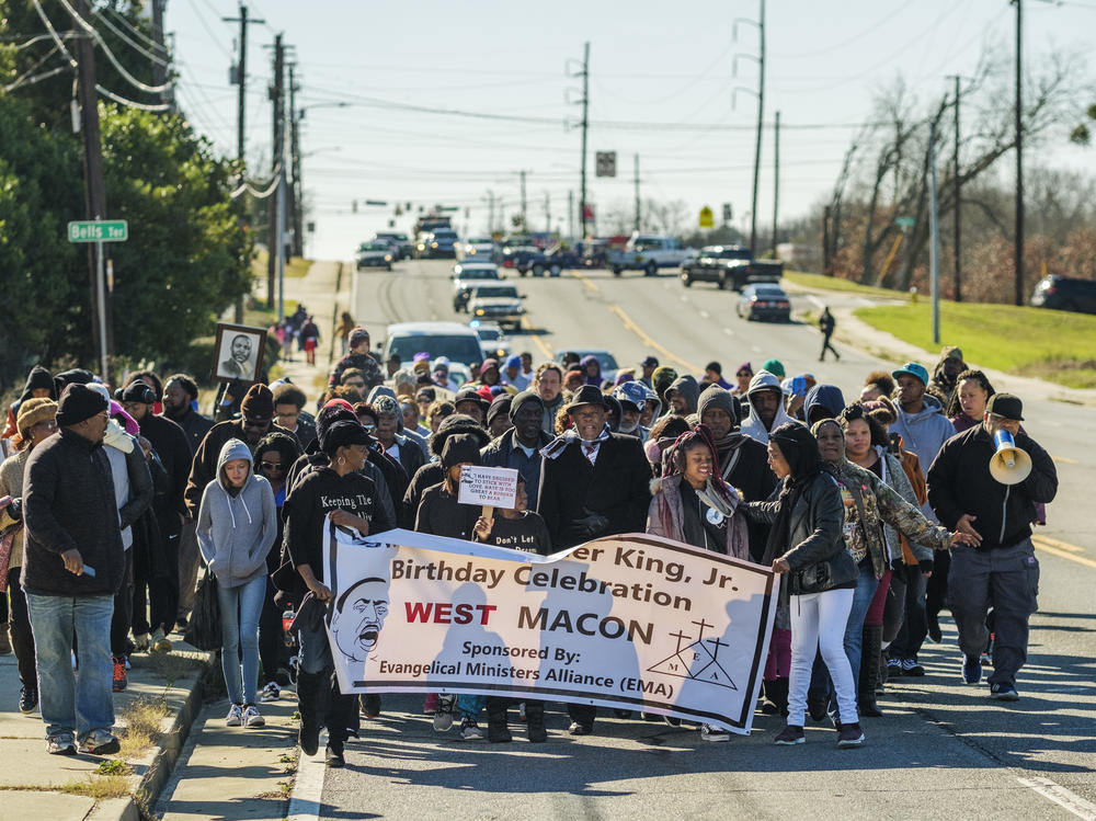 The contingent from the west side of Macon marches down Pio Nono Avenue on the way to meet up with people from the north, south and east sides of the city for the annual celebration of the birthday of Martin Luther King, Jr.