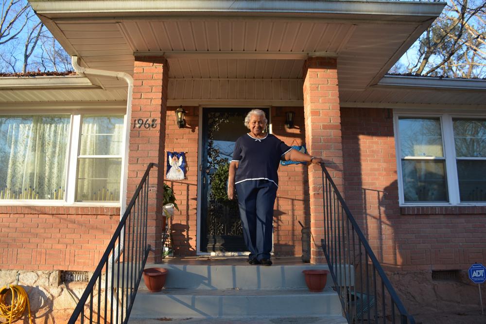Bernice Smith on the front steps of her home where she raised her grandson.