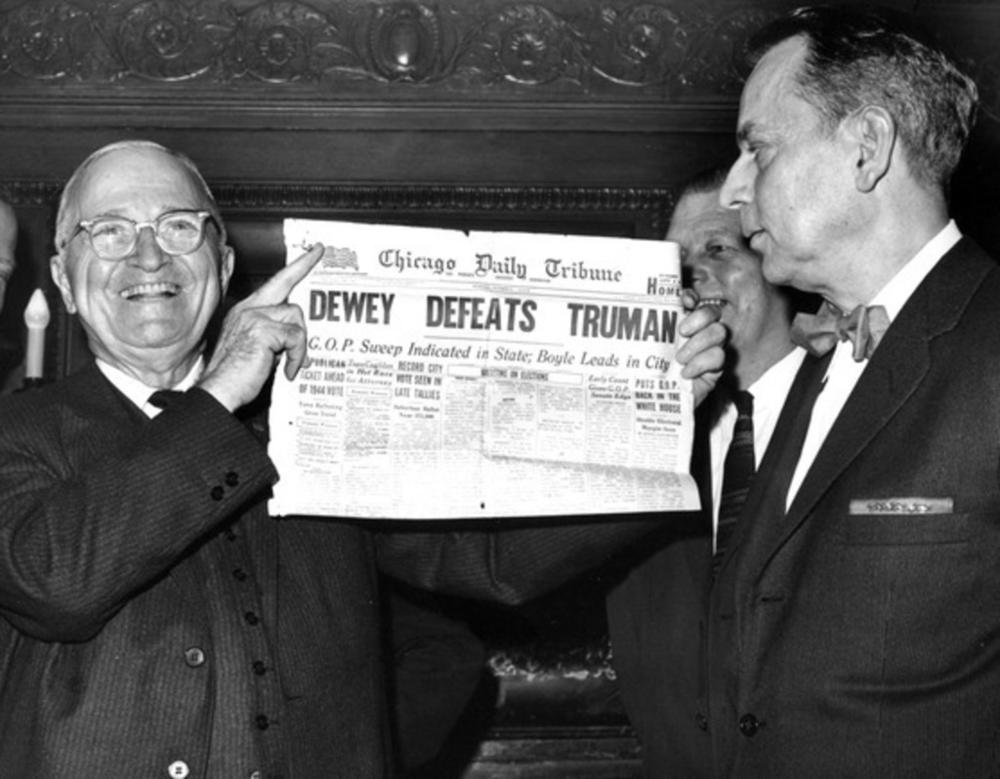 A smiling President Harry S. Truman (left) holds a copy of the famous Chicago Daily Tribune paper declaring 