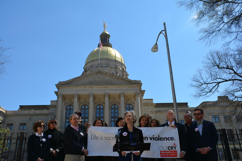 Members of Outcry in front of the state Capitol.