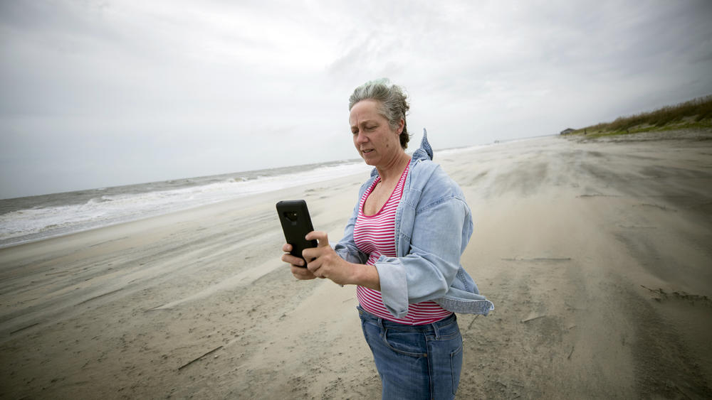 Crystal Travaille takes a cell phone photo of the wind and seas on the beach as Hurricane Dorian makes its way up the East Coast.
