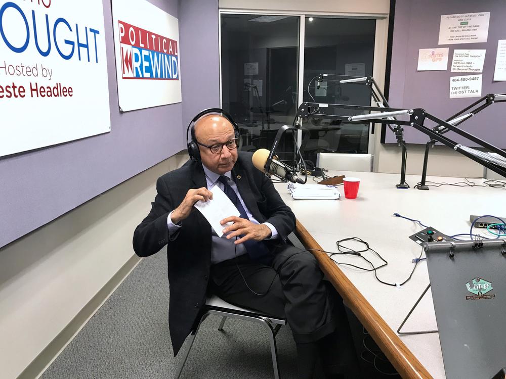 Khizr Khan at the GPB studios, holding his pocket copy of the U.S. Constitution.