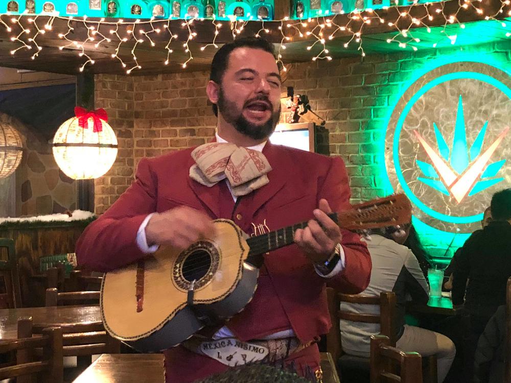 Luis Vazquez (r) sings in front of a crowd of diners at Agavero Cantina in Lilburn, Georgia.