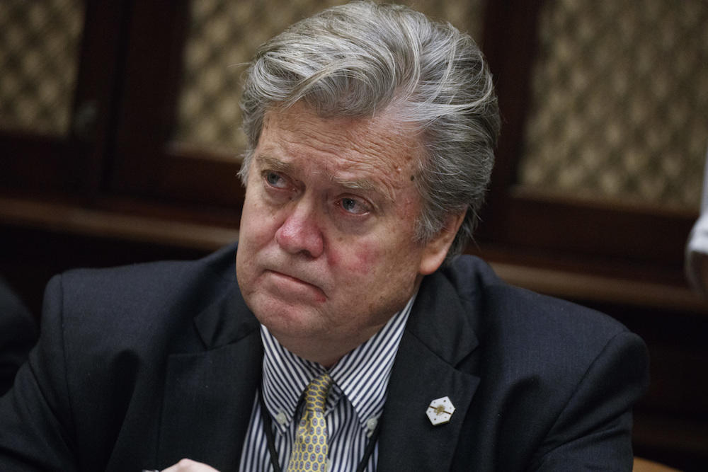 In this file photo from , Feb. 7, 2017, Steve Bannon listens as President Donald Trump speaks during a meeting with county sheriffs in the Roosevelt Room of the White House in Washington.